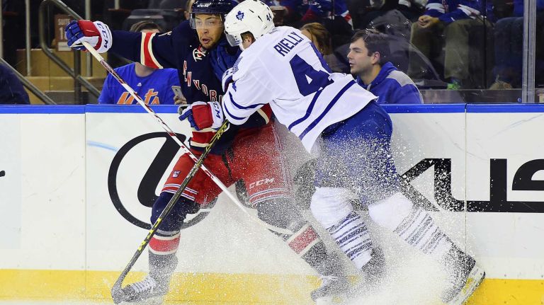 New York Rangers right wing Mats Zuccarello (36) is checked into the boards by Toronto Maple Leafs defenseman Morgan Rielly (44) during the first period of a game at Madison Square Garden on Friday, Oct. 30, 2015.