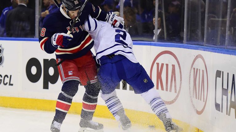 New York Rangers center Dominic Moore (28) and Toronto Maple Leafs defenseman Matt Hunwick (2) battle for the puck during the first period of a game at Madison Square Garden on Friday, Oct. 30, 2015.