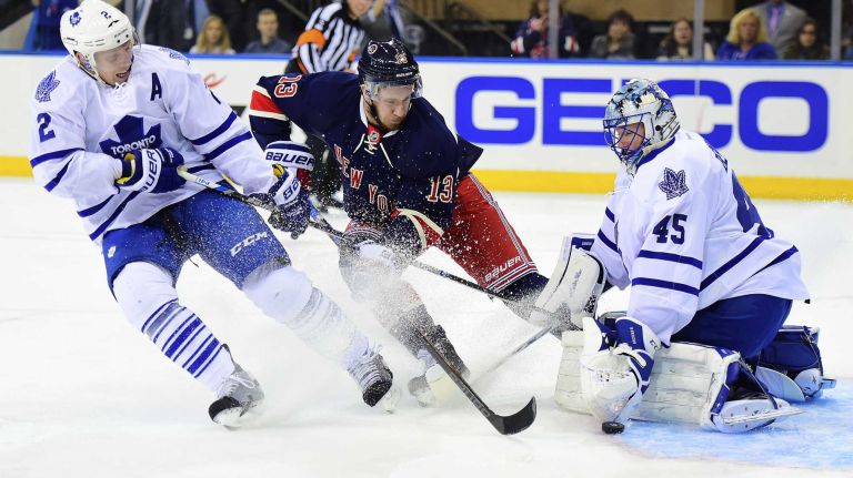 New York Rangers right wing Kevin Hayes (13) has his shot stopped by Toronto Maple Leafs goalie Jonathan Bernier (45) under pressure from defenseman Matt Hunwick (2) during the first period of a game at Madison Square Garden on Friday, Oct 30, 2015.