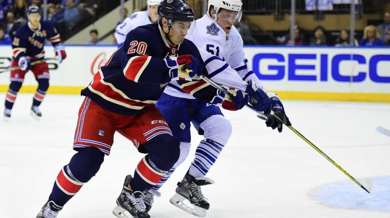 New York Rangers left wing Chris Kreider (20) and Toronto Maple Leafs defenseman Jake Gardiner (51) chase down the puck during the first period of a game at Madison Square Garden on Friday, Oct 30, 2015.