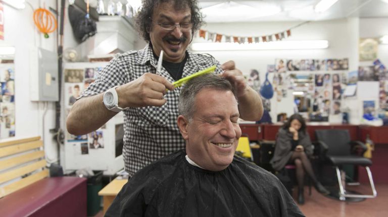 Alberto Amore cuts New York City mayoral-elect Bill de Blasio's hair at Astor Place Hairstylists in Manhattan. (Oct. 29, 2013)