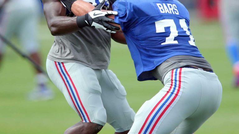 New York Giants defensive end Owamagbe Odighizuwa blocks defensive end Brad Bars in a drill during training camp at the Quest Diagnostics Training Center in East Rutherford, N.J., on Saturday, Aug. 8, 2015.