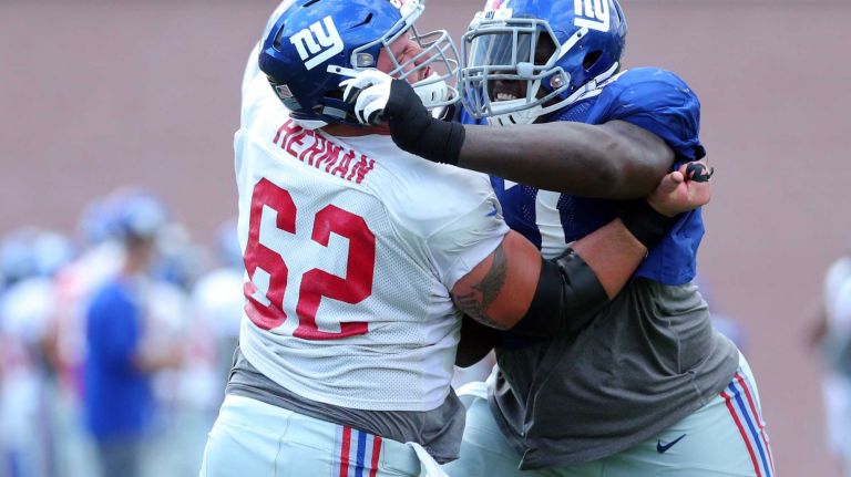 New York Giants defensive tackle Kenrick Ellis works on guard Eric Herman during training camp at the Quest Diagnostics Training Center in East Rutherford, N.J., on Wednesday, Aug. 5, 2015.