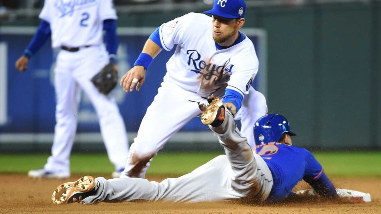 World Series Game 1: Mets vs. Royals 83 New York Mets center fielder Juan Lagares (12) steals 2nd base in the eighth inning as Kansas City Royals second baseman Ben Zobrist (18) waits for throw during Game 1 of the World Series against the Kansas City Royals at Kauffman Stadium on Tuesday, Oct. 27, 2015.