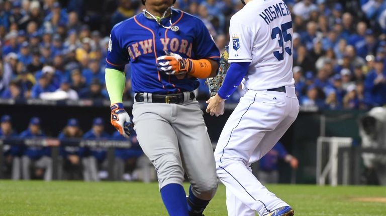 World Series Game 1: Mets vs. Royals 110 New York Mets center fielder Yoenis Cespedes (52) is out at 1st base in the second inning as Kansas City Royals first baseman Eric Hosmer (35) steps on base during Game 1 of the World Series against the Kansas City Royals at Kauffman Stadium on Tuesday, Oct. 27, 2015.