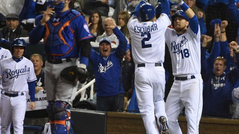 World Series Game 1: Mets vs. Royals 126 Kansas City Royals shortstop Alcides Escobar (2) high fives teammate Kansas City Royals second baseman Ben Zobrist (18) after the inside the park homerun in the first inning during Game 1 of the World Series against the Kansas City Royals at Kauffman Stadium on Tuesday, Oct. 27, 2015.