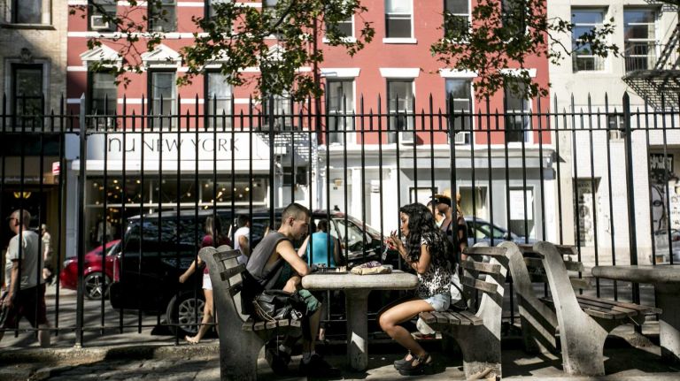Warren Wry, 21, and Jessica Boafo, 23, both of Toronto, Cananda, play chess in Desalvio Playground in NoLita in Manhattan, on August 4, 2015.