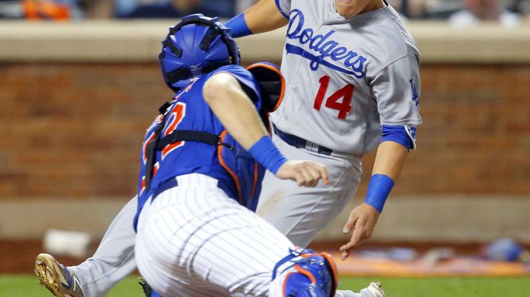 Enrique Hernandez #14 of the Los Angeles Dodgers is tagged out at home in the fifth inning by Kevin Plawecki #22 of the Mets at Citi Field on Friday, July 24, 2015.