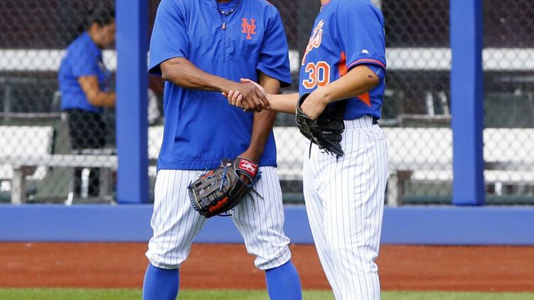 Michael Conforto of the Mets talks with Curtis Granderson during batting practice before a game against the Los Angeles Dodgers at Citi Field on Friday, July 24, 2015.
