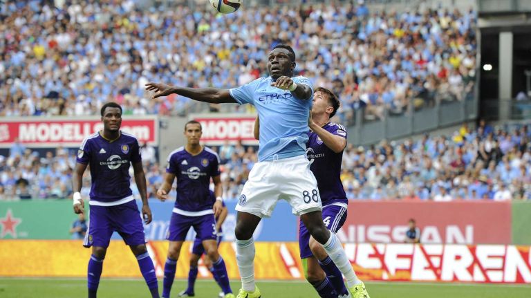 New York City FC midfielder Kwadwo Poku (88) goes for a header under pressure from Orlando City FC defender Sean St. Ledger (4) in an MLS game at Yankee Stadium on Sunday, July 26, 2015.