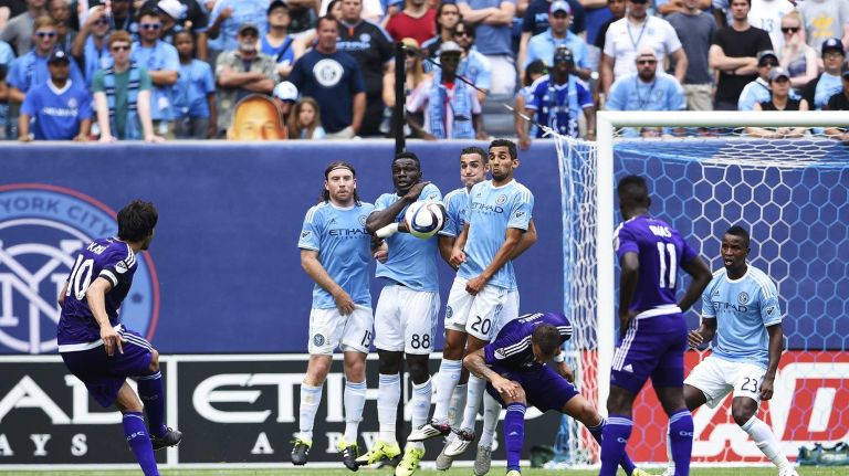 New York City FC forms a wall to defend a shot from Orlando City FC midfielder Kaka in an MLS game at Yankee Stadium on Sunday, July 26, 2015.