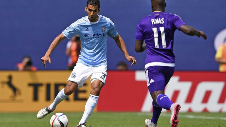 New York City FC midfielder Mehdi Ballouchy (20) is defended by Orlando City FC midfielder Carlos Rivas (11) in an MLS game at Yankee Stadium on Sunday, July 26, 2015.