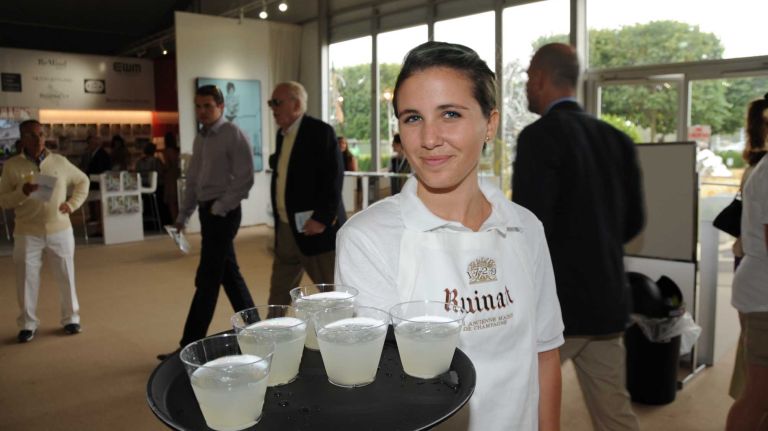 Waitress Katie McKeough serves drinks at the Art Southampton VIP first view & VIP preview to benefit Southampton Hospital & Parrish Art Museum in Water Mill, Thursday, July 9, 2015. The art show runs from July 9 through July 13. 