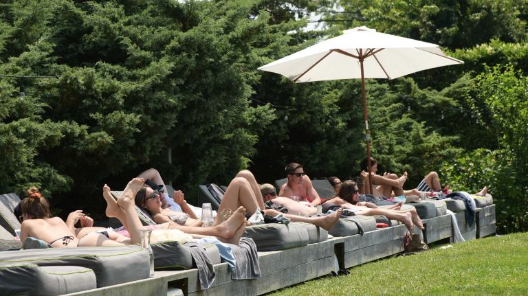 Taking in some rays at the Jazz and Bossa Nova Brunch with Marcello and Ludmilla at Sole East on July 5, 2015 in Montauk. 
