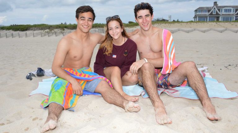 Left- Alejandro Osio, Ava Pollack, and Miles Edelstein hang out at Ocean Road Beach in Bridgehampton, Saturday July 4th, 2015.