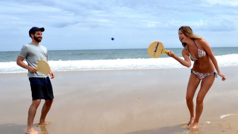 Jason and Ashley Modica play paddle ball on Saturday, July 4, 2015, at Sagg Main beach in Sagaponack.