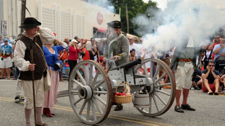 Patriot re-enactors firing the cannon at the Fourth of July parade on July 4, 2015, in Southampton.