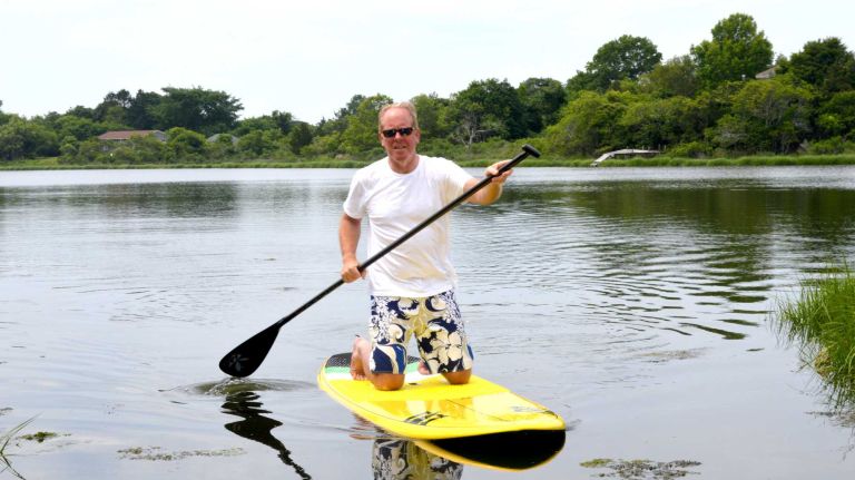 Steve Bonebrake paddleboards in Heady Creek in Southampton, Saturday, July 4, 2015.