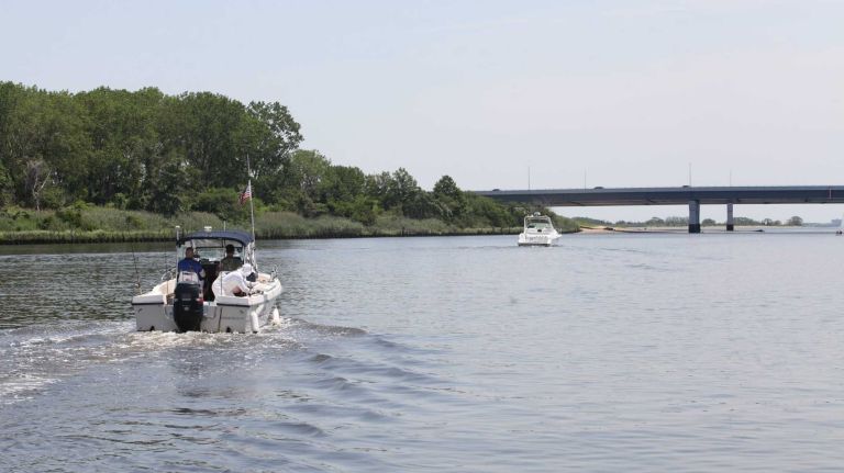 Bergen Beach 35 Boaters in the Paerdegast Basin with the Belt Parkway in the background in Bergen Beach, Brooklyn, July 3, 2015.