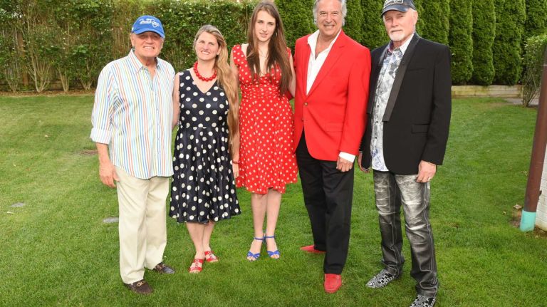 Bruce Johnston, Broadway producer Bonnie Comley, Leah Lane, Broadway producer Stewart Lane, and Mike Love pose before The Beach Boys concert featuring Love and Johnston at Guild Hall on July 3, 2015 in East Hampton.