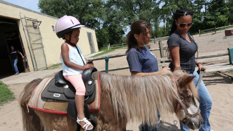 Bergen Beach 48 Kennedy Tynes, 3, has a pony ride at the Jamaica Bay Riding Academy in Bergen Beach, Brooklyn, July 3, 2015.