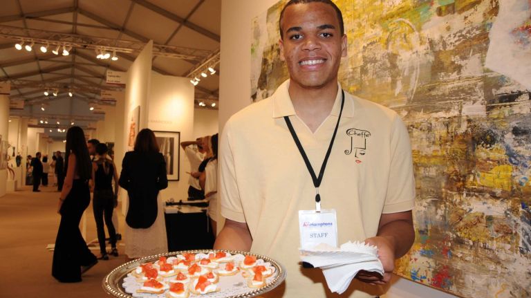 Sampson George serves goodies at the opening Thursday, July 2, 2015, of ArtHamptons in Bridgehampton.