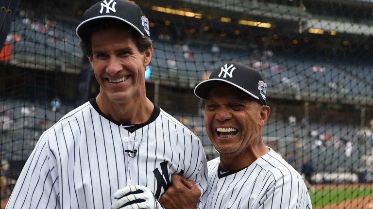 Former New York Yankees Paul O'Neill, left, and Reggie Jackson share a moment at batting practice during the 69th Old-Timers' Day at Yankee Stadium before a baseball game between the Yankees and the Detroit Tigers on Saturday, June 20, 2015.