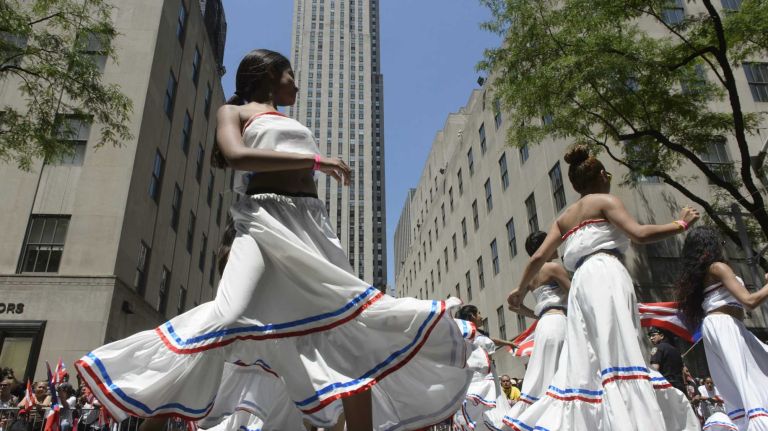 Participants dances along 5th Avenue during the 58th annual Puerto Rican Day Parade in Manhattan on June 14, 2015. The annual parade celebrates Puerto Rican heritage and culture. It is one of the largest parades in New York City.