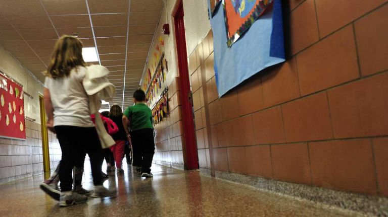 A first-grade class returns to the classroom.