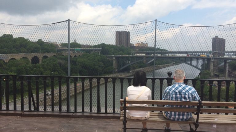 Visitors to the newly reopened High Bridge look north toward the Alexander Hamilton Bridge over the Harlem River on Tuesday, June 9, 2015. Remnants of the Old Croton Aqueduct are also visible in the lefthand side of the image. 