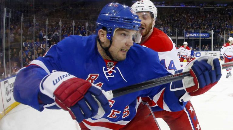 Rick Nash #61 of the New York Rangers is checked in the first period by Brooks Orpik #44 of the Washington Capitals during Game 1 of the Eastern Conference semifinals at Madison Square Garden on Thursday, April 30, 2015.