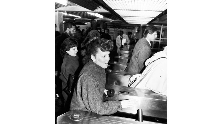 A commuter goes through the turnstile at the 179th Street IND station. (Jan. 19, 1987)