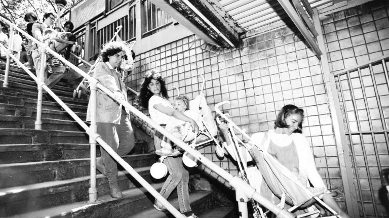 Mothers, some with toddlers in tow, entering the subway station at City Hall on the N and R lines in protest over a ban on strollers. (May 25, 1990)