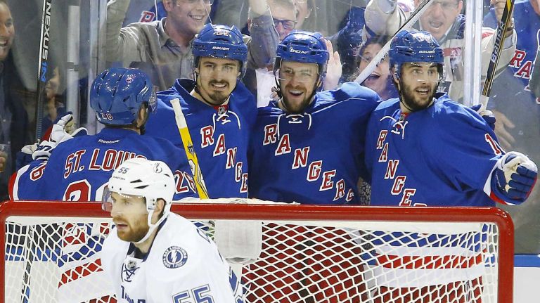Derek Stepan #21 of the New York Rangers celebrates his second-period goal against the Tampa Bay Lightning with teammates Chris Kreider #20, Martin St. Louis #26 and Derick Brassard #16 during Game 2 of the Eastern Conference finals at Madison Square Garden on Monday, May 18, 2015.
