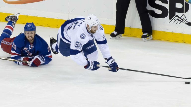 The New York Rangers' Derek Stepan falls with Braydon Coburn of the Tampa Bay Lightning while fighting for the puck in the first period during Game 2 of the Eastern Conference finals at Madison Square Garden on Monday, May 18, 2015.