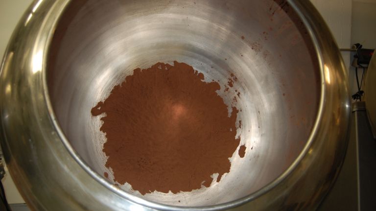 Nuts and other items are tossed in chocolate, cocoa powder and other yummy substances in this pan-coating machine, one of three at Jacques Torres Chocolates.