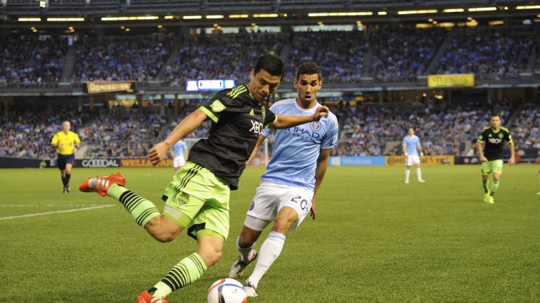 New York City FC vs. Sounders 30 Seattle Sounders FC midfielder Gonzalo Pineda (8) attempts to clear the ball past New York City FC midfielder Mehdi Ballouchy (20) in an MLS game at Yankee Stadium on Sunday, May 3, 2015.