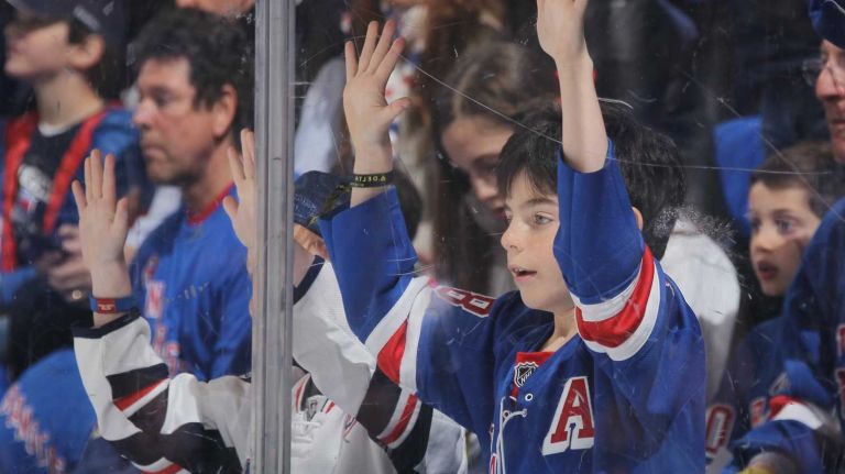 Rangers fans bang on the glass during pregame warmups before Game 1 of the Eastern Conference semifinals against the Washington Capitals during the 2015 NHL Stanley Cup playoffs at Madison Square Garden on April 30, 2015.