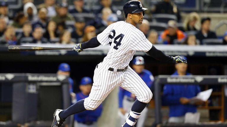 Chris Young #24 of the New York Yankees follows through on a second-inning RBI base hit against the New York Mets at Yankee Stadium on Sunday, April 26, 2015.