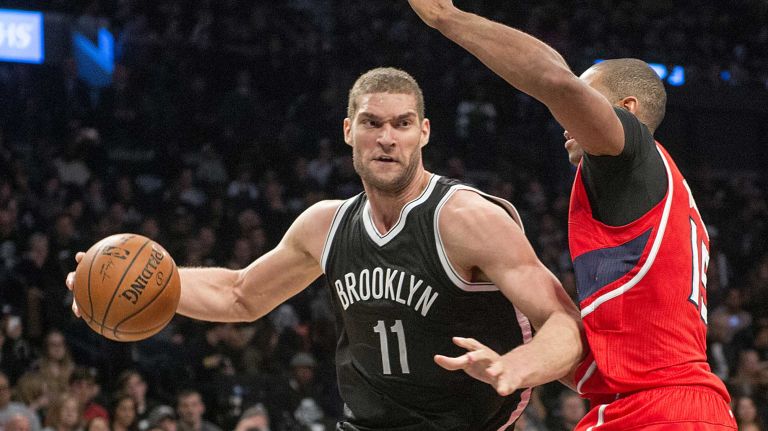 Brooklyn Nets' Brook Lopez drives against Al Horford of the Atlanta Hawks in the fourth quarter during Game 3 of the Eastern Conference quarterfinals at Barclays Center on Saturday, April 25, 2015.