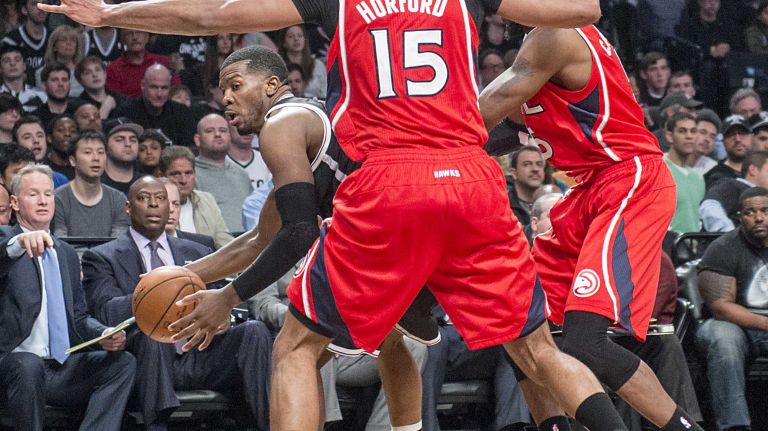 Brooklyn Nets' Joe Johnson fights his way out of a trap against the Atlanta Hawks' Al Horford and DeMarre Carroll in the fourth quarter during Game 3 of the Eastern Conference quarterfinals at Barclays Center on Saturday, April 25, 2015.