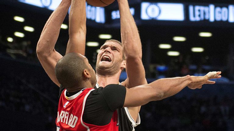 Brooklyn Nets' Brook Lopez shoots over Al Horford of the Atlanta Hawks in the fourth quarter during Game 3 of the Eastern Conference quarterfinals at Barclays Center on Saturday, April 25, 2015.