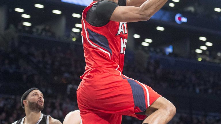Brooklyn Nets' Deron Williams watches as Atlanta Hawks' Al Horford attempts a layup in the first quarter during Game 3 of the Eastern Conference quarterfinals at Barclays Center on Saturday, April 25, 2015.