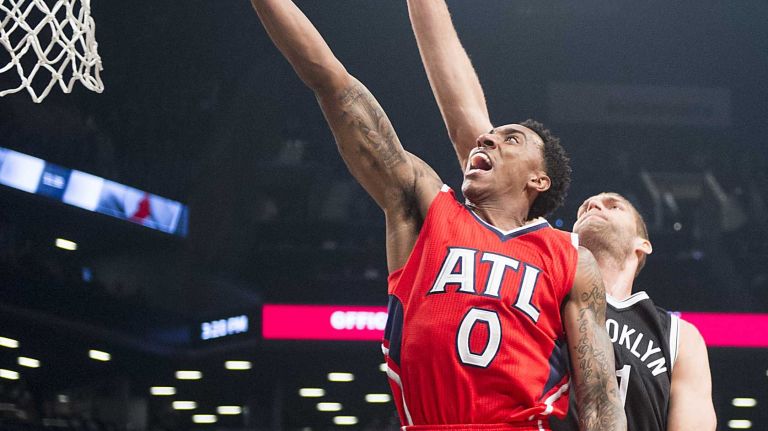 Brooklyn Nets' Brook Lopez tries to cover Atlanta Hawks' Jeff Teague in the first quarter during Game 3 of the Eastern Conference quarterfinals at Barclays Center on Saturday, April 25, 2015.