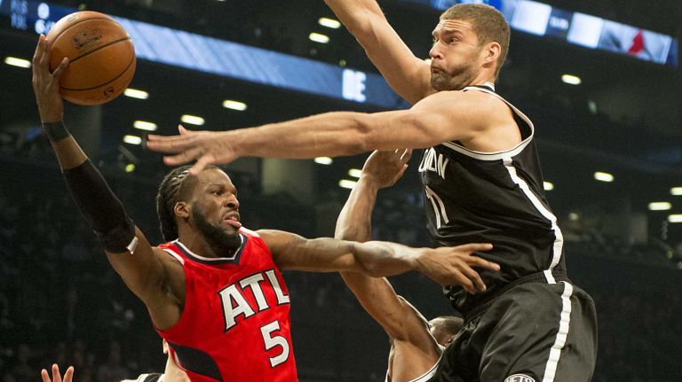 Brooklyn Nets' Brook Lopez forces the Atlanta Hawks' DeMarre Carroll to pass the ball in the first quarter during Game 3 of the Eastern Conference quarterfinals at Barclays Center on Saturday, April 25, 2015.