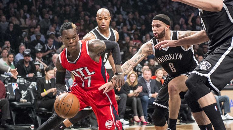 Atlanta Hawks' Dennis Schroder drives around the defense of Brooklyn Nets' Jarrett Jack, Deron Williams and Brook Lopez in the first quarter during Game 3 of the Eastern Conference quarterfinals at Barclays Center on Saturday, April 25, 2015.