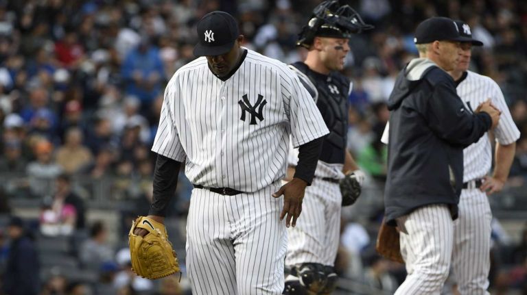 New York Yankees starting pitcher CC Sabathia walks to the dugout after being taken out of the game during the sixth inning against the New York Mets in a baseball game at Yankee Stadium on Saturday, April 25, 2015.