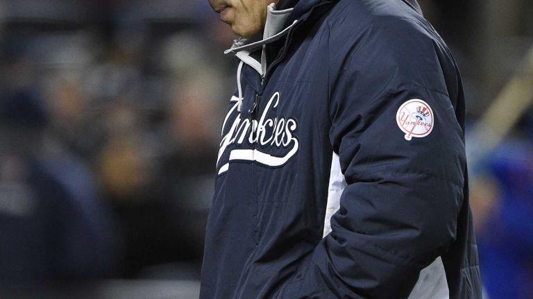 New York Yankees manager Joe Girardi walks to the dugout in a baseball game against the New York Mets at Yankee Stadium on Friday, April 24, 2015.