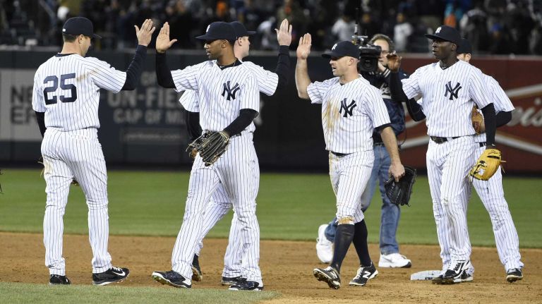 The New York Yankees celebrate their 6-1 win against the New York Mets in a baseball game at Yankee Stadium on Friday, April 24, 2015.
