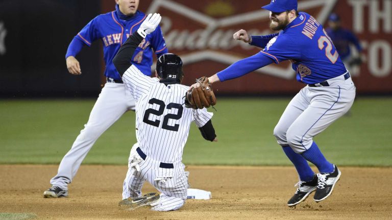 New York Yankees centerfielder Jacoby Ellsbury is safe at second against New York Mets second baseman Daniel Murphy, right, and New York Mets shortstop Wilmer Flores in a baseball game at Yankee Stadium on Friday, April 24, 2015.